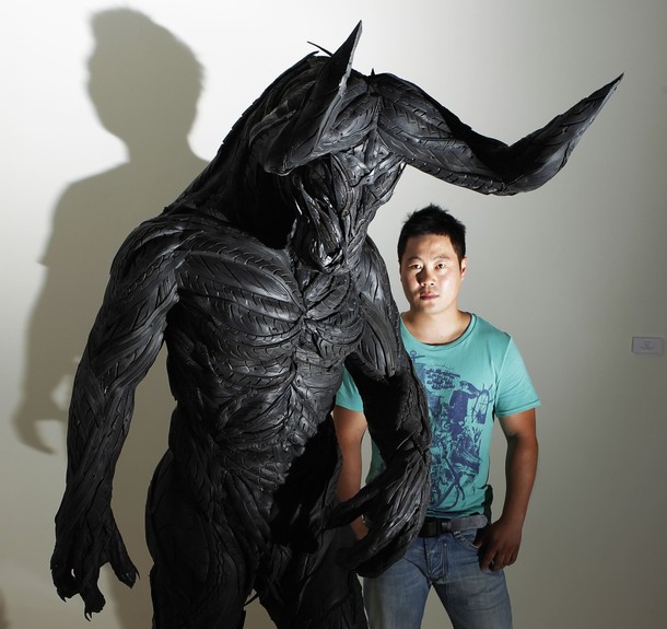 Artist Ji Yong Ho poses with his sculptue "Bullman 4" before the launch of the Korean Eye : Fantastic Ordinary exhibition at the Saatchi Gallery in Chelsea west London